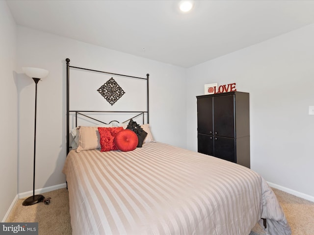 bedroom featuring baseboards and carpet