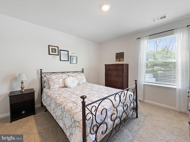carpeted bedroom with baseboards and visible vents