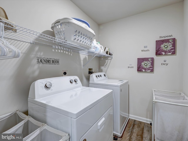 washroom with washing machine and clothes dryer, laundry area, dark wood finished floors, and baseboards