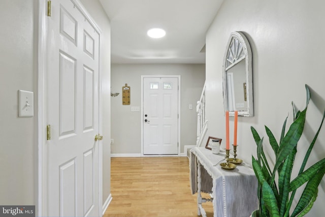 entryway with baseboards and light wood-style floors