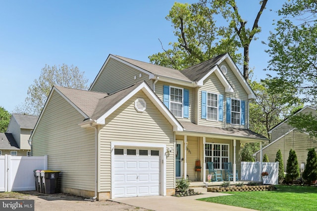 view of front of property featuring a porch, fence, an attached garage, concrete driveway, and a front lawn