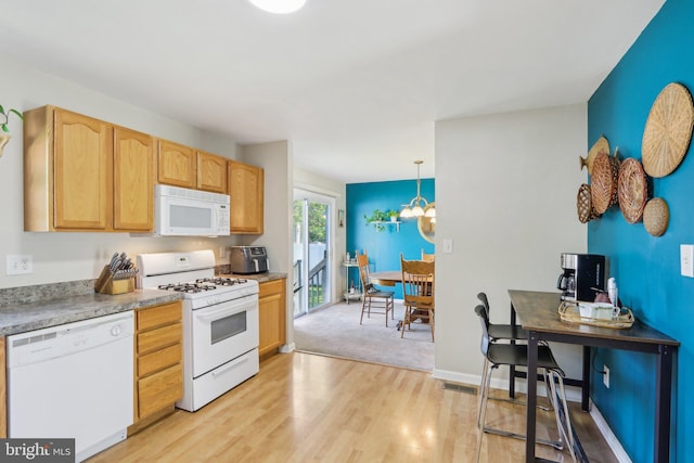 kitchen with white appliances, light wood-type flooring, visible vents, a chandelier, and light brown cabinetry