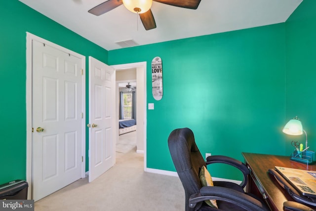 office with visible vents, baseboards, ceiling fan, and carpet floors