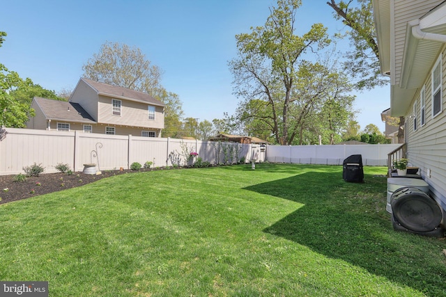 view of yard with a fenced backyard