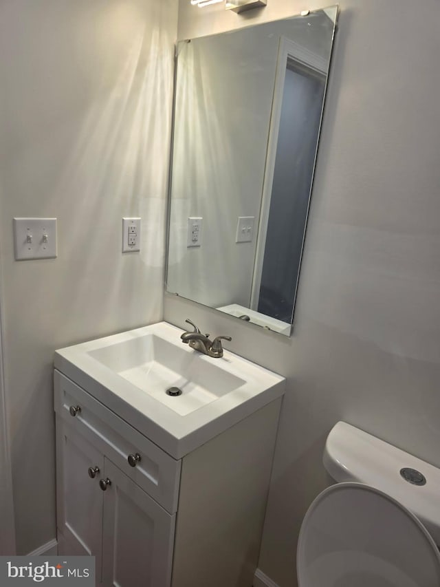 bathroom featuring toilet and vanity