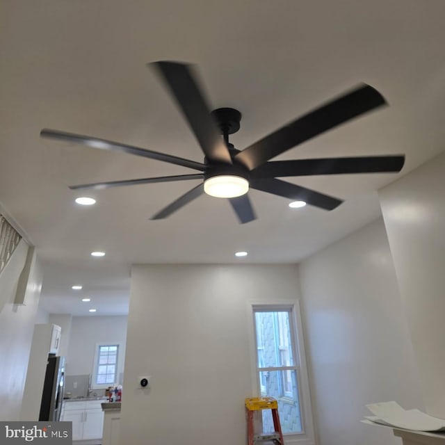 details with recessed lighting, a ceiling fan, and freestanding refrigerator