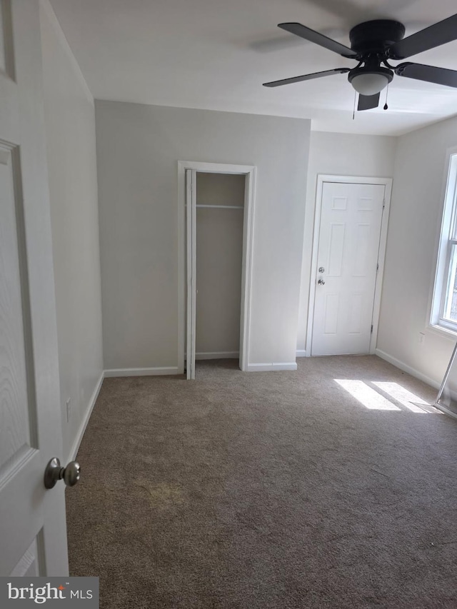 unfurnished bedroom featuring baseboards, ceiling fan, and carpet