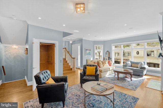 living area with stairs, recessed lighting, crown molding, and light wood-style floors
