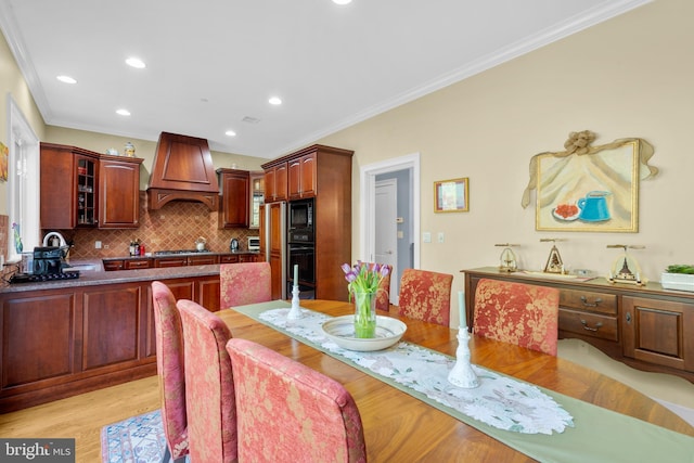 dining area with recessed lighting, ornamental molding, and light wood finished floors