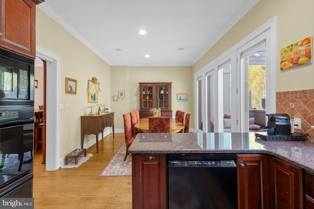 kitchen featuring ornamental molding, a peninsula, recessed lighting, light wood finished floors, and black appliances