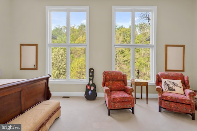living area with baseboards, carpet flooring, and visible vents