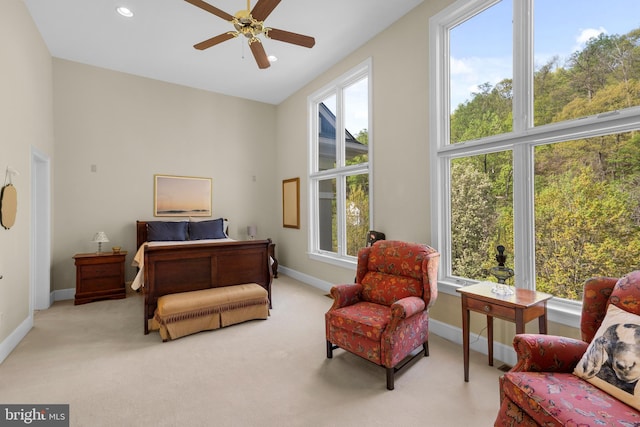 carpeted bedroom with baseboards, recessed lighting, and a towering ceiling