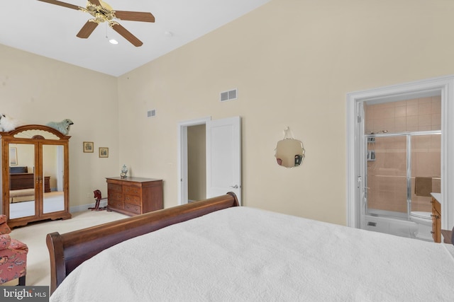 bedroom with visible vents, a ceiling fan, connected bathroom, and a high ceiling