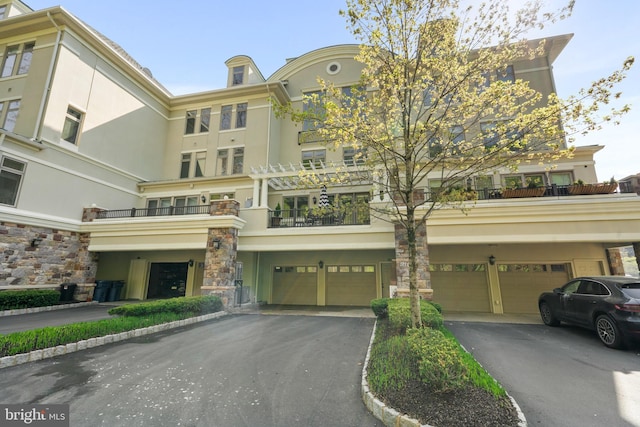 view of building exterior featuring a garage and driveway