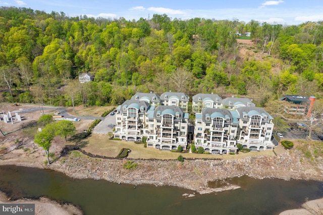 birds eye view of property with a water view and a view of trees