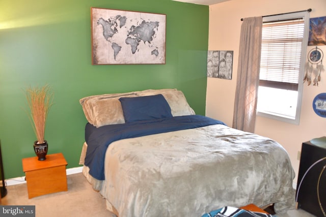 bedroom featuring baseboards and carpet