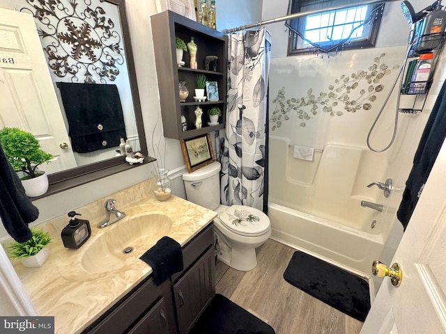 bathroom featuring vanity, wood finished floors, shower / bath combo, and toilet