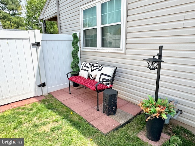view of patio / terrace featuring fence and a gate