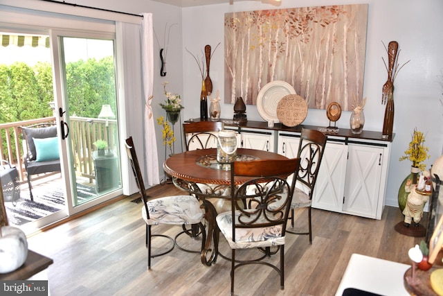 dining space with wood finished floors