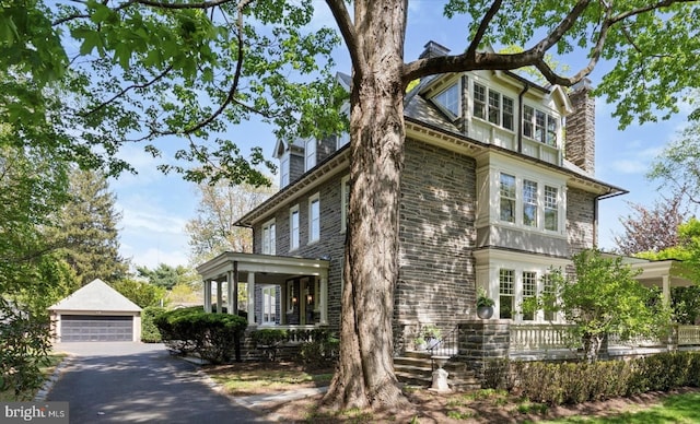 view of front of property featuring a garage and stone siding