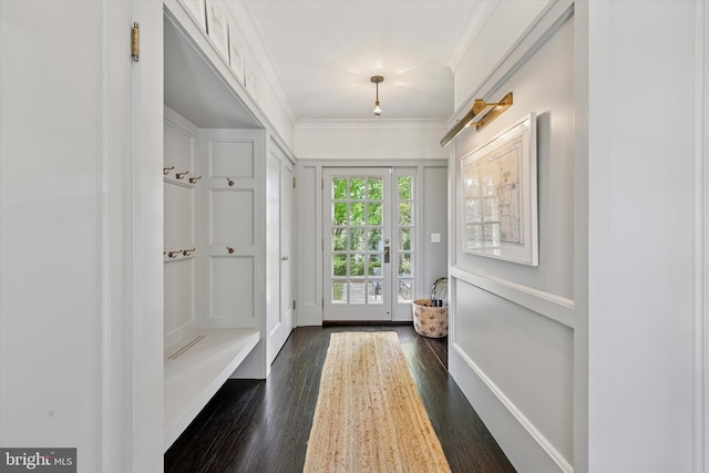 mudroom with dark wood-type flooring and crown molding