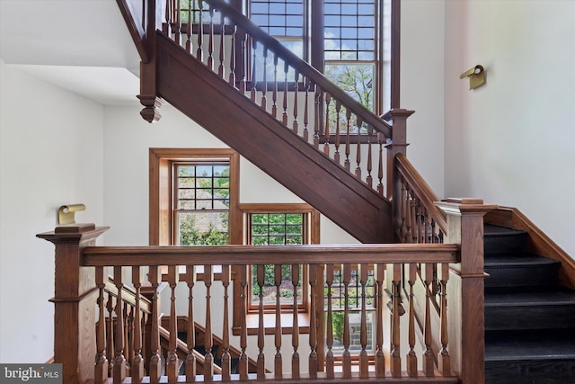 staircase featuring a high ceiling