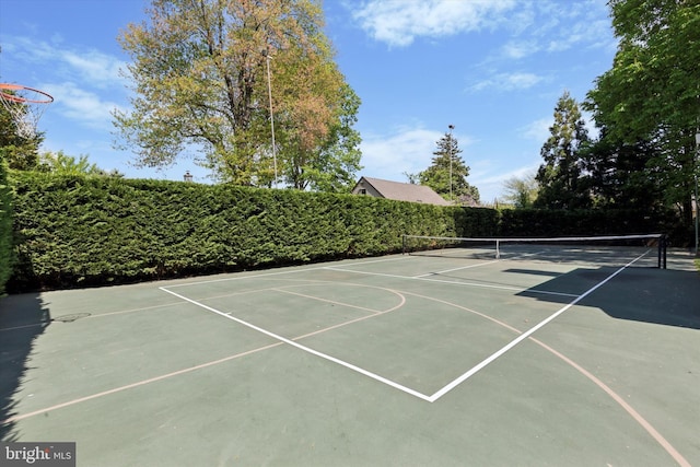 view of sport court with a tennis court, fence, and community basketball court
