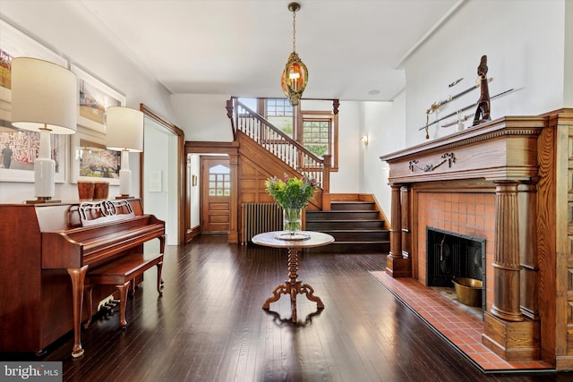 interior space featuring a fireplace, wood-type flooring, and stairs