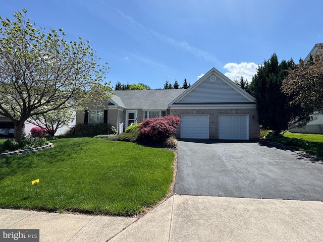 ranch-style house featuring an attached garage, driveway, brick siding, and a front yard