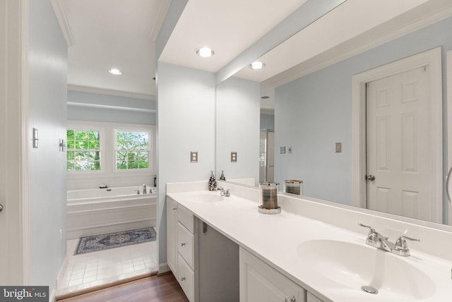 bathroom featuring a sink, crown molding, a garden tub, and double vanity