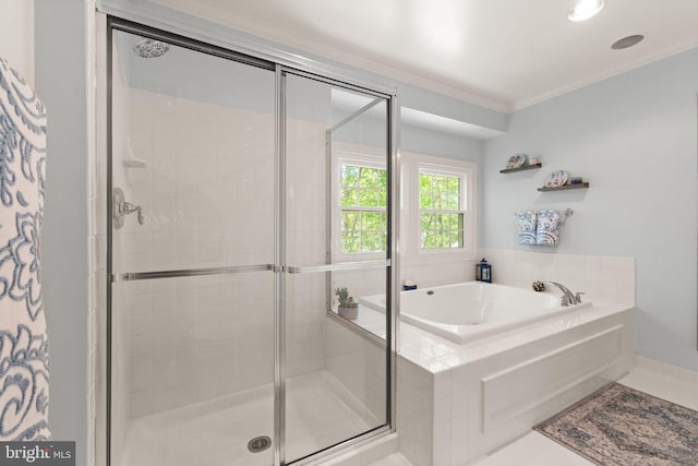 bathroom featuring ornamental molding, a bath, and a stall shower