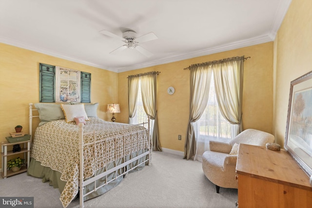 carpeted bedroom with baseboards, ornamental molding, and a ceiling fan
