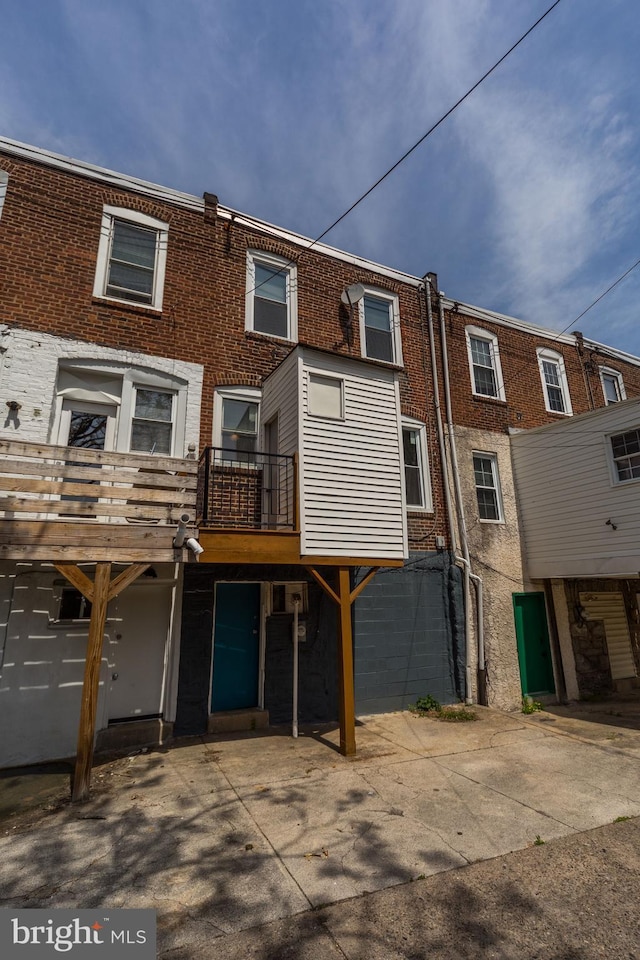 back of property featuring brick siding