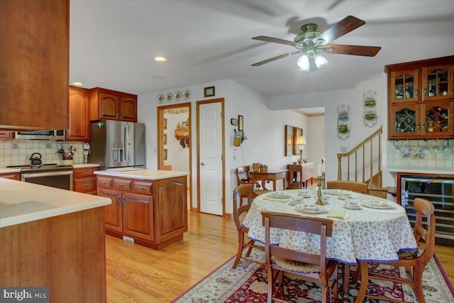 8 Roger Ave, Shippensburg, PA 17257 - kitchen featuring appliances with stainless steel finishes, light countertops, backsplash, light wood-style floors, and brown cabinetry