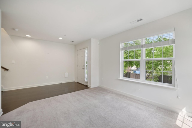 7201 Wood Pond Cir, Lanham, MD 20706 - unfurnished living room with baseboards, dark colored carpet, and recessed lighting