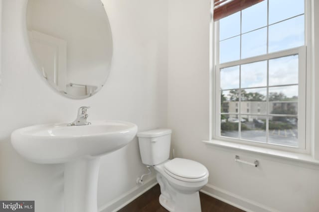 7201 Wood Pond Cir, Lanham, MD 20706 - bathroom with baseboards, toilet, and wood finished floors