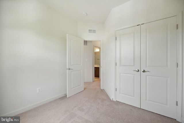 7201 Wood Pond Cir, Lanham, MD 20706 - unfurnished bedroom featuring light colored carpet, baseboards, and a closet