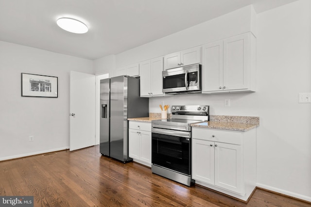 kitchen featuring dark wood-style flooring, stainless steel appliances, baseboards, and white cabinets