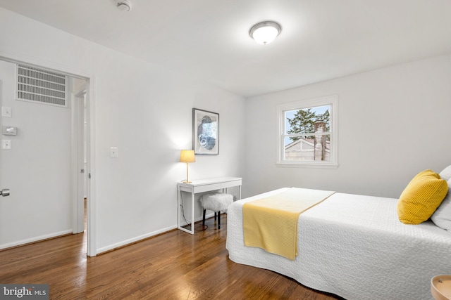 bedroom featuring baseboards and wood finished floors