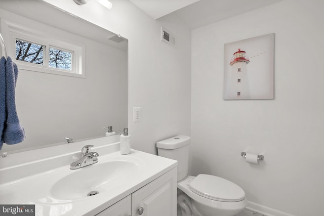 bathroom with visible vents, toilet, and vanity