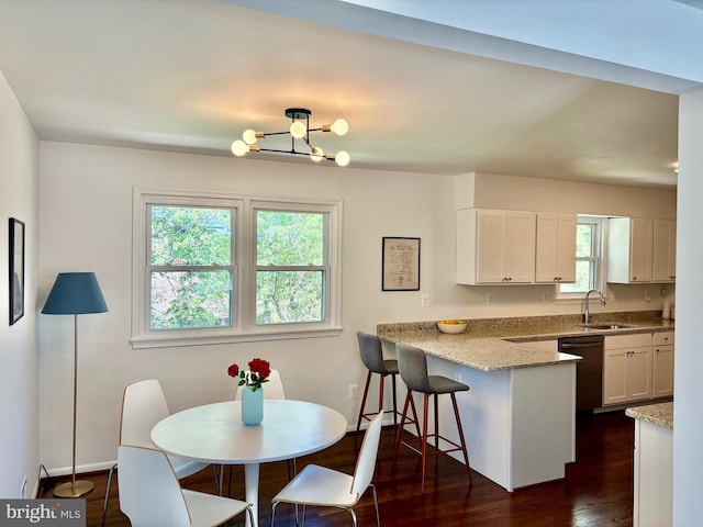 dining room with baseboards, a chandelier, and dark wood-style floors