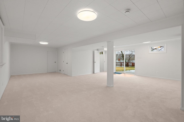 below grade area featuring carpet flooring and baseboards