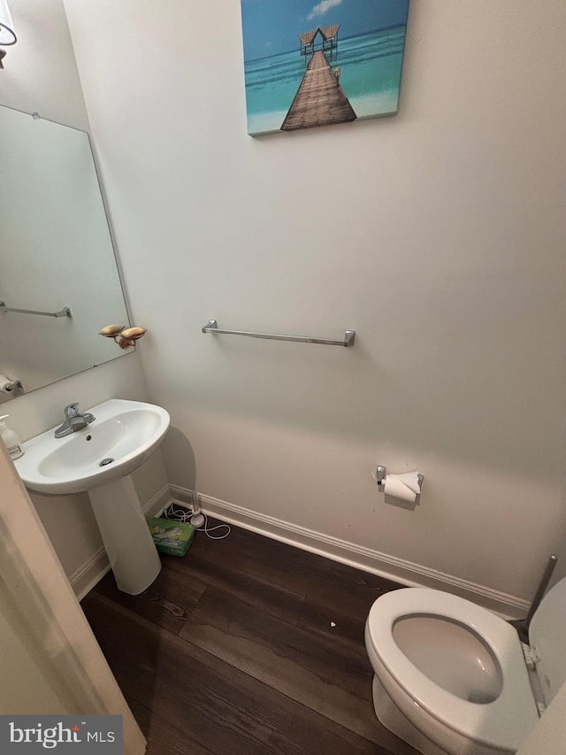 916 Holden Ct, Warminster, PA 18974 - half bathroom featuring toilet, baseboards, and wood finished floors