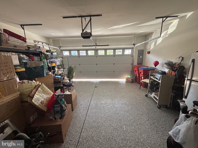 916 Holden Ct, Warminster, PA 18974 - garage featuring freestanding refrigerator, a garage door opener, and electric panel