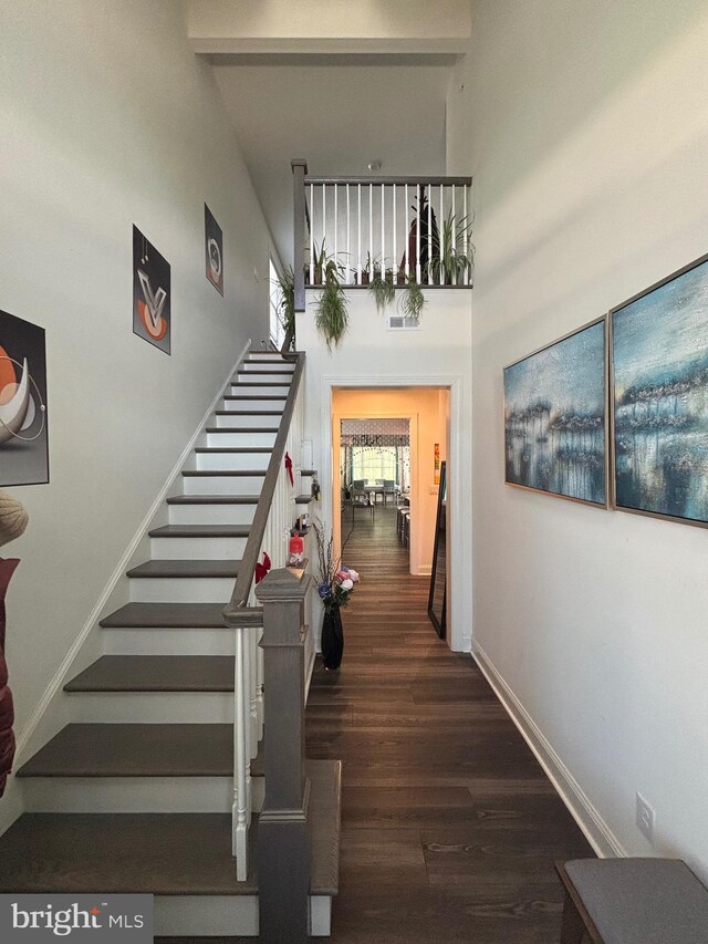 916 Holden Ct, Warminster, PA 18974 - stairs featuring baseboards, a towering ceiling, and wood finished floors