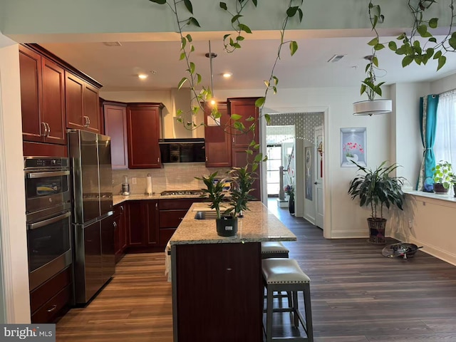 916 Holden Ct, Warminster, PA 18974 - kitchen with light stone countertops, a center island, stainless steel appliances, backsplash, and dark wood-style floors