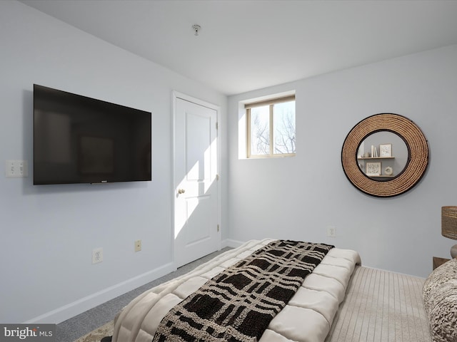 bedroom with baseboards and carpet