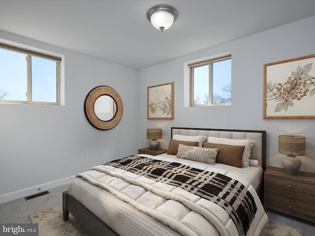 bedroom featuring baseboards, visible vents, and carpet