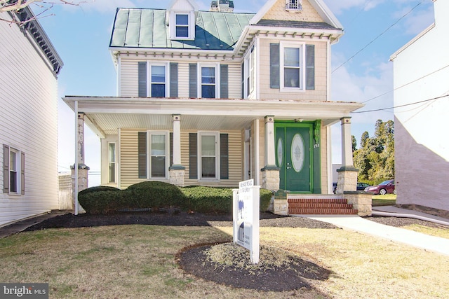 view of front of house with a standing seam roof, covered porch, and metal roof