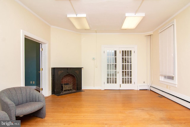 living area with crown molding, baseboards, and light wood-style floors